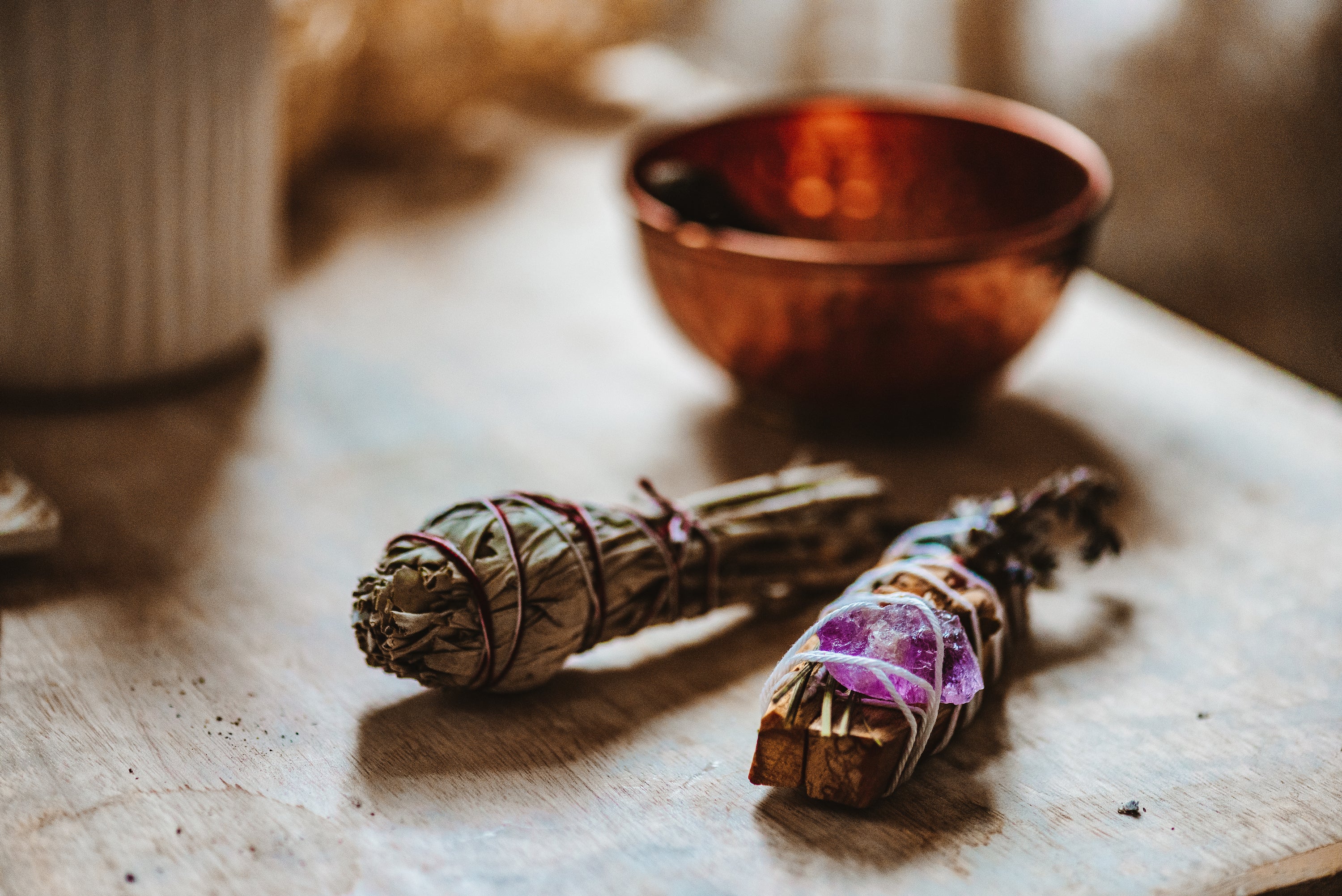 white sage smudge stick and an amethyst crystal