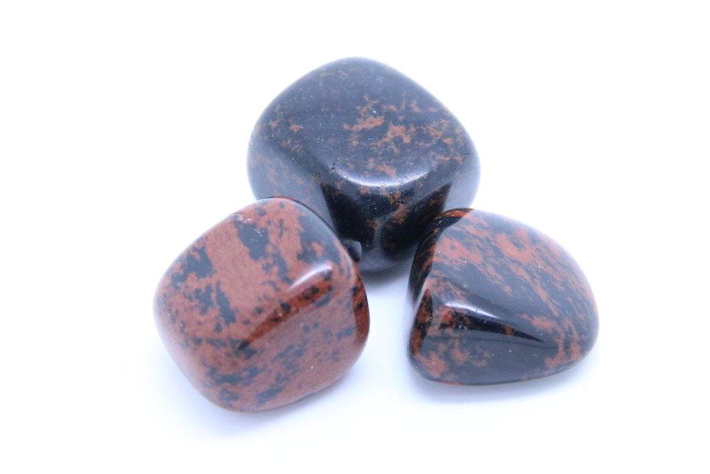 Black and (iron-rich)  mahogany brown volcanic glass made when lava is super cooled in water (sea).