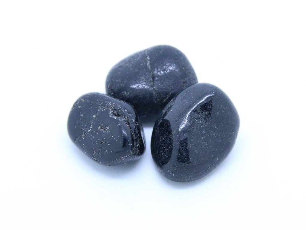 A crystalline boron silicate mineral. Black and lusterous, often flatish tumblestone