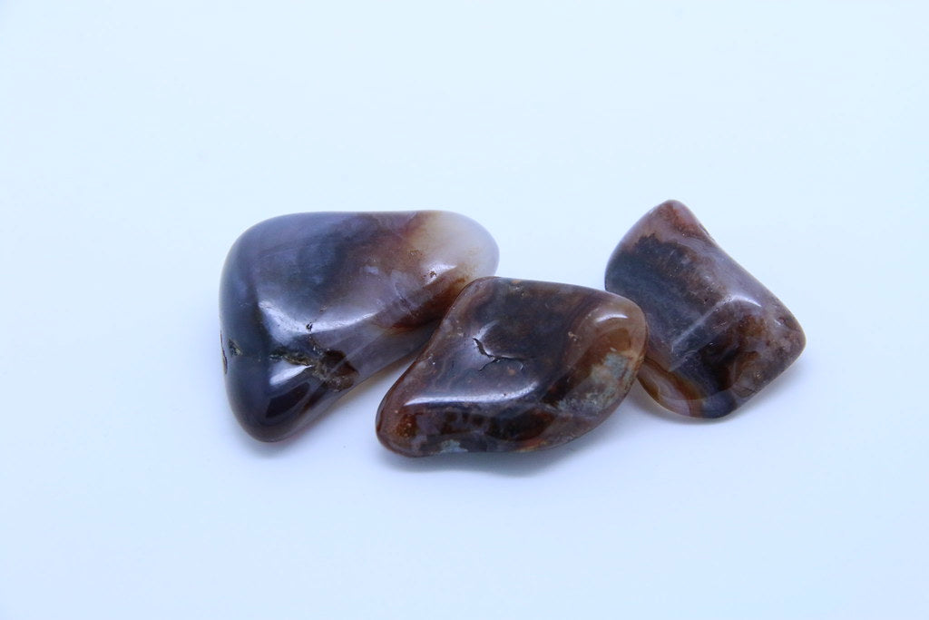 Agate with colours of white, cream and brown. It has a burnt coffee look to it and often has non-angular imperfections and form